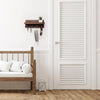 A rustic wooden key holder organizer mounted on a white wall next to a wooden bed frame.