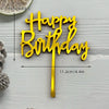 Gold acrylic birthday cake topper with the words Happy Birthday on a stick