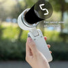 A hand holds a white foldable mini handheld fan with a five-speed wind adjustment feature.