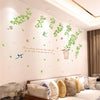 A wall decal featuring various green and pink rose vines and leaves on a white wall.