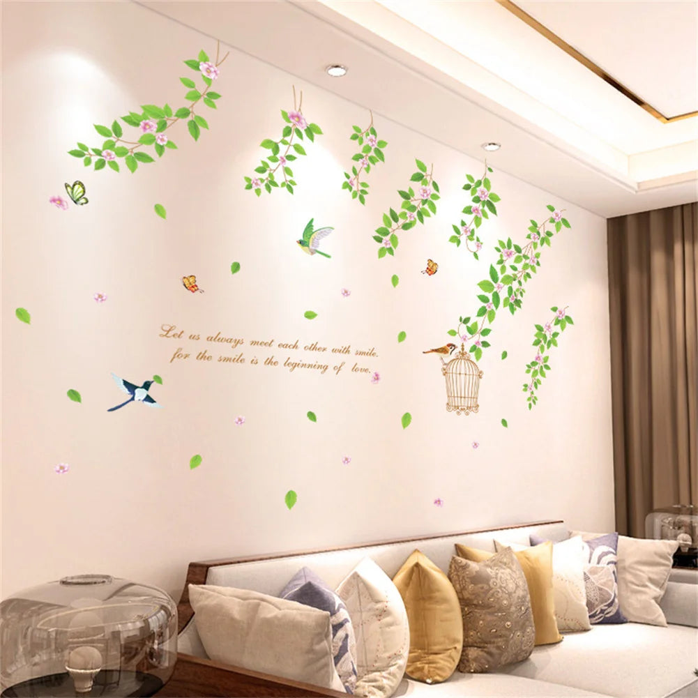 A wall decal featuring various green and pink rose vines and leaves on a white wall.