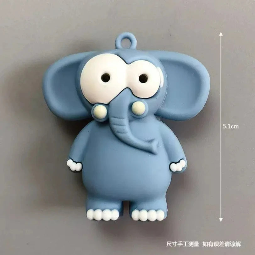 A light blue cartoon elephant fridge magnet with large eyes and rounded ears.