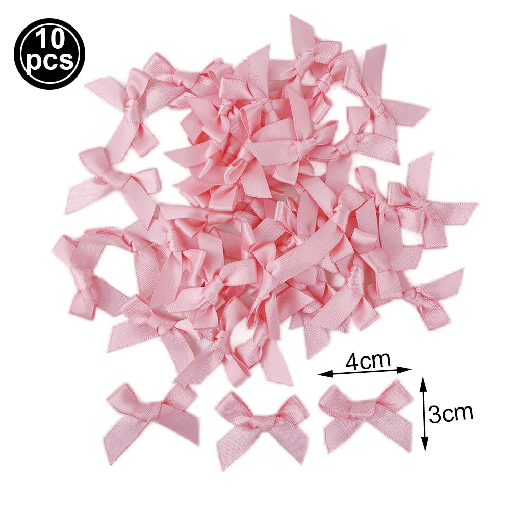 A set of ten pink satin ribbon bows used as cupcake toppers for parties.