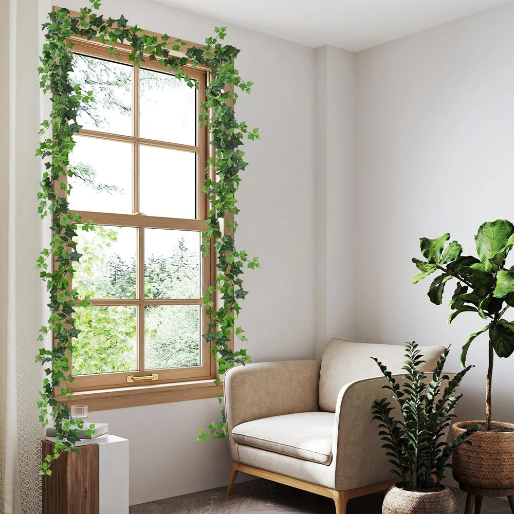 An artificial ivy garland frames a window with wooden trim in a bright room.