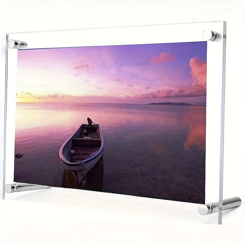 An acrylic photo frame displaying a sunset over the ocean with a small boat silhouette.