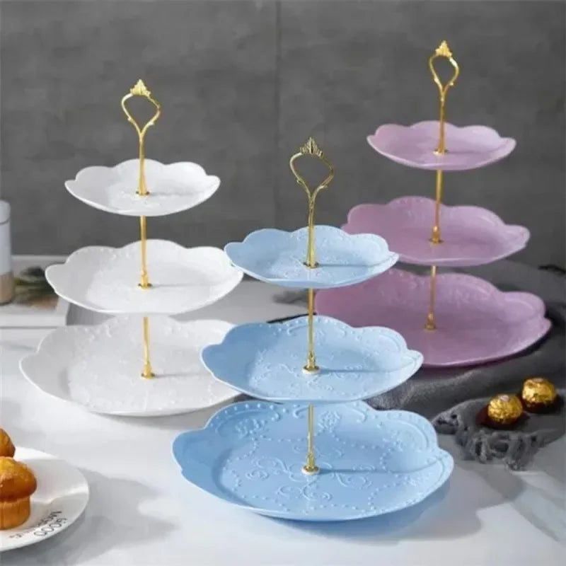 A set of three gold-stemmed, pastel blue and pink ceramic tiers for a detachable cake stand.