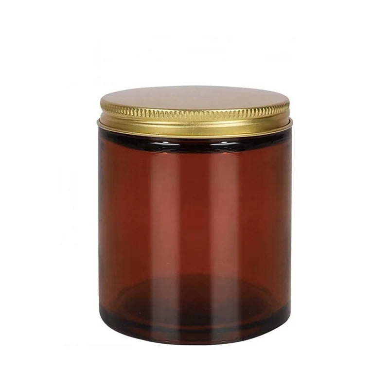 A set of two amber glass candle jars with airtight metal lids.