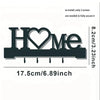 A black letter-shaped metal wall key holder spelling HOME with four hooks.