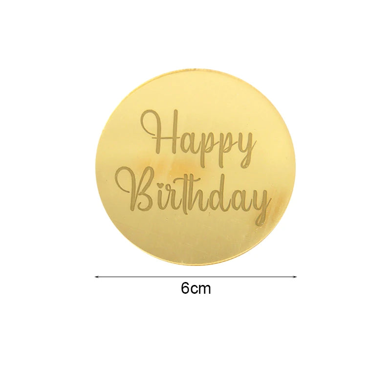 A round gold acrylic birthday topper with the text Happy Birthday engraved on it.