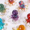 A collection of natural crystal octopus statues in various colors including green, purple, and red