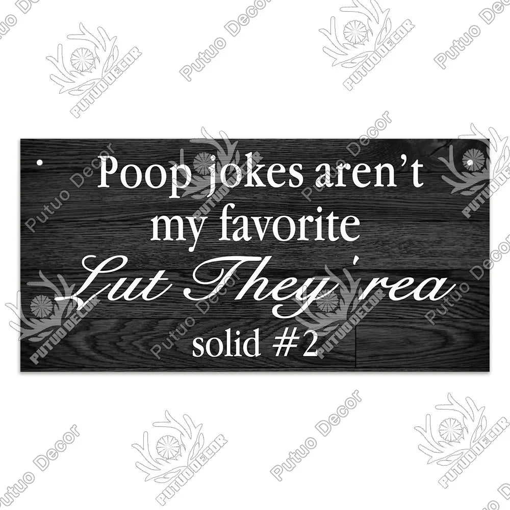 A dark wooden sign with white text that reads Poop jokes aren't my favorite Lut They're solid #2