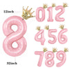 Pink aluminum foil crown number balloons spelling out 012 and 456789