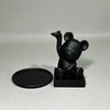 A black bear-shaped jewelry and accessory tray with a small, elongated feature.