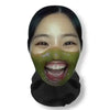 A person wearing a green face mask with visible teeth, used as funny carnival headgear for cosplay.