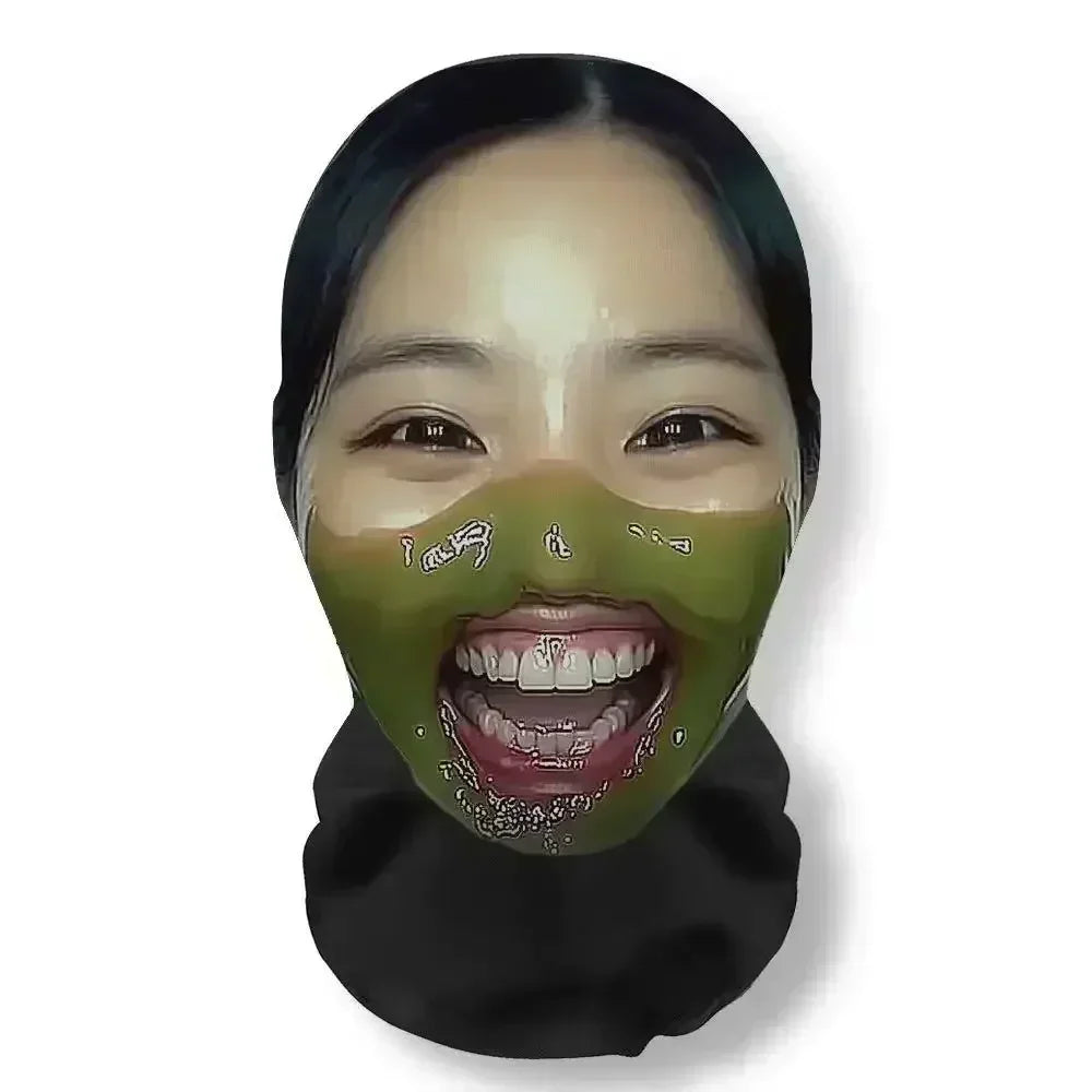 A person wearing a green face mask with visible teeth, used as funny carnival headgear for cosplay.