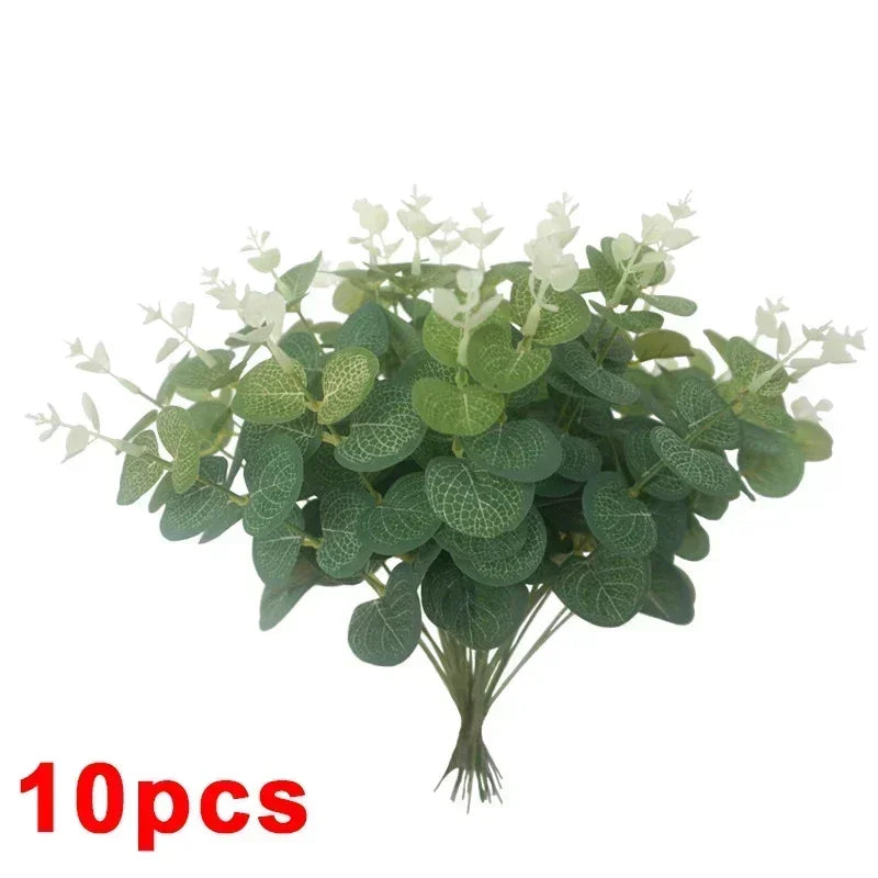 A bunch of artificial eucalyptus stems with green leaves and white flowers for home decor.