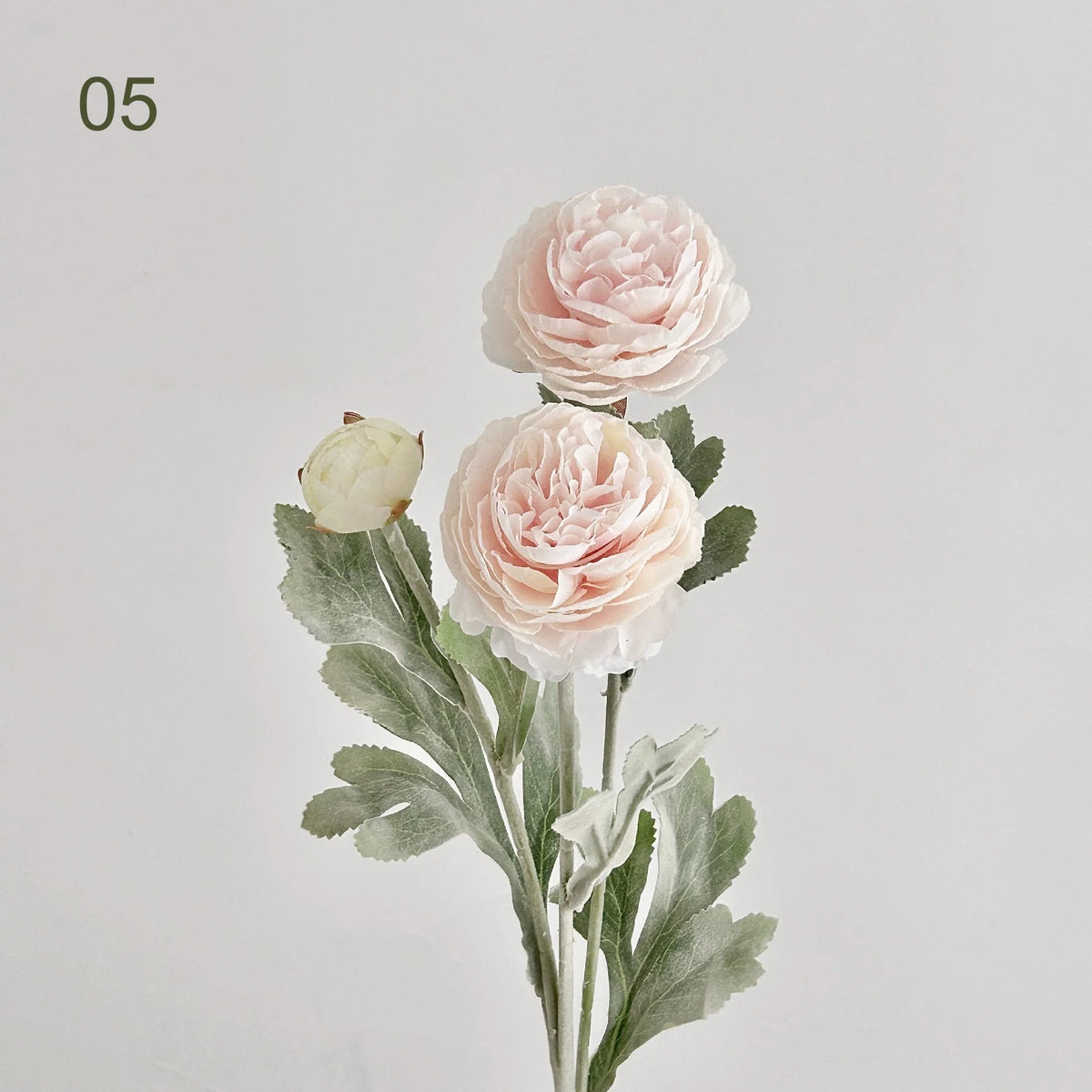 A delicate pink peony flower arrangement featuring lush petals and green foliage.