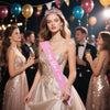 A woman wearing a sparkling crown and pink sash is featured in a festive birthday celebration.