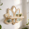 A decorative wooden lotus floating shelf with multiple mirrored cutouts mounted on a white wall.