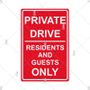 A vintage red metal warning sign with white text that reads PRIVATE DRIVE RESIDENTS AND GUESTS ONLY