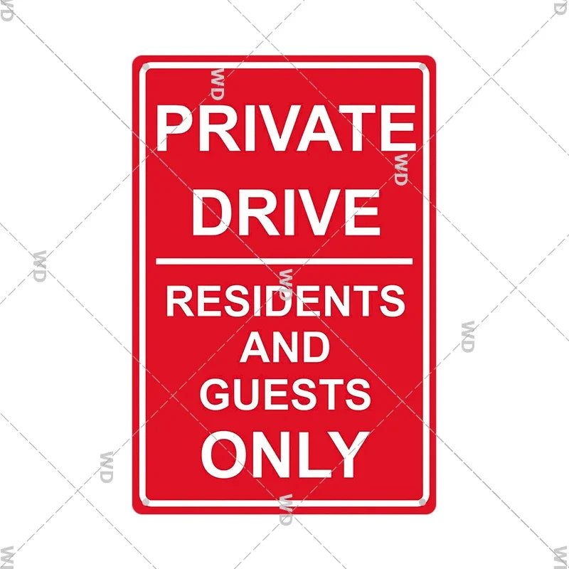 A vintage red metal warning sign with white text that reads PRIVATE DRIVE RESIDENTS AND GUESTS ONLY