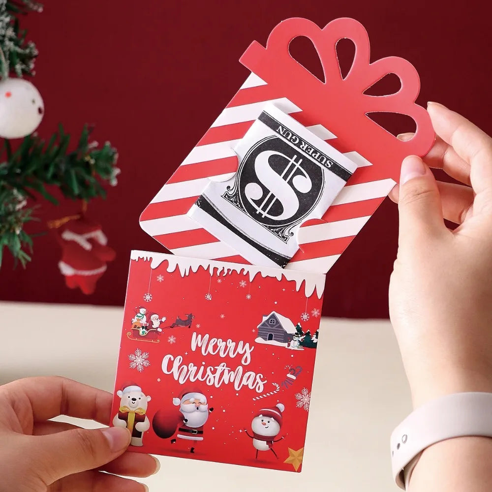 A hand holds a set of three red and white cartoon Christmas thank you cards with festive designs against a dark red backgroun