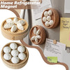 A set of realistic 3D steamer bun and dumpling fridge magnets in a wooden holder.