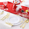 Elegant white and gold disposable dinnerware set with cutlery placed on a red festive cloth.