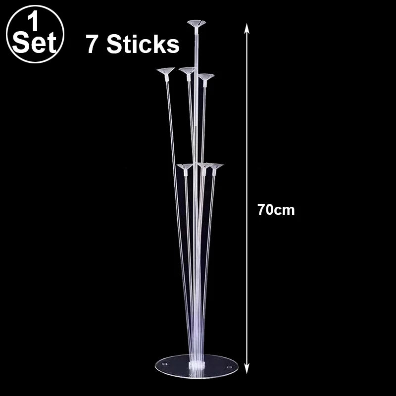 A set of seven clear, thin sticks arranged vertically on a circular base for balloon display.