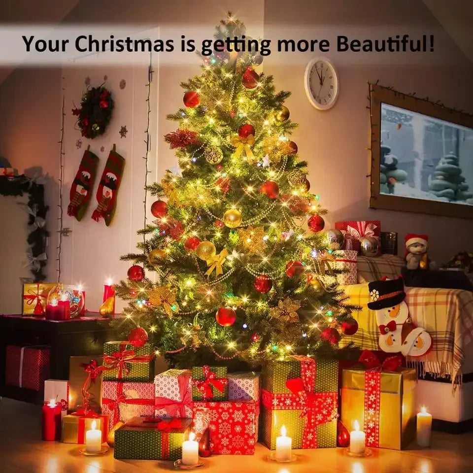 A brightly lit Christmas tree decorated with red ornaments and wrapped gifts in a home setting.