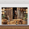 A rustic western backdrop featuring a wooden barn door, a horse, and various rustic props like cacti and lanterns.
