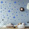 Blue star shaped acrylic mirror wall stickers decorating a gray wall with a lion face accent