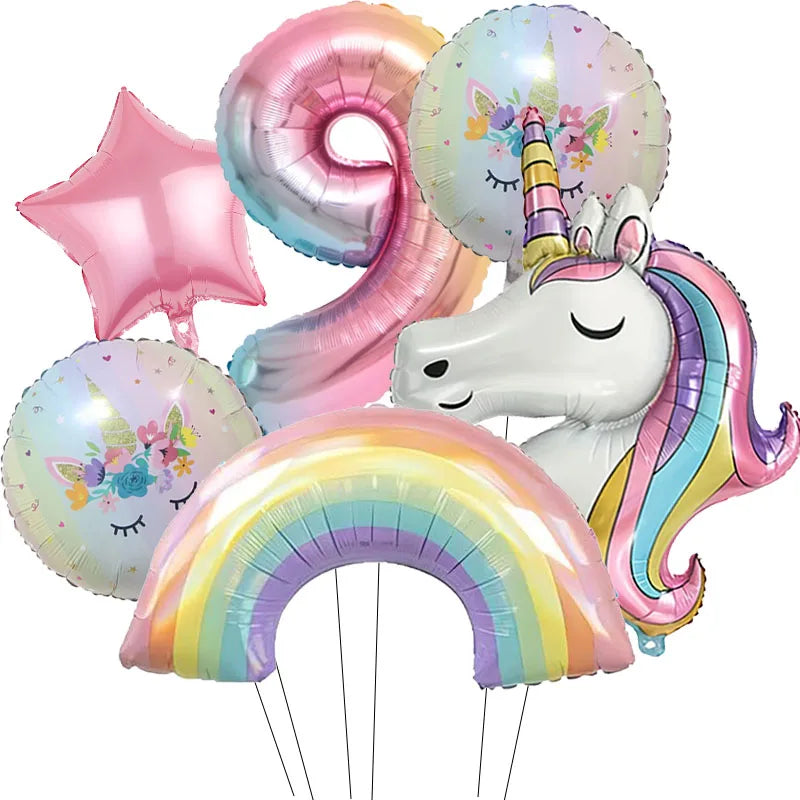 A collection of iridescent foil balloons featuring a rainbow and unicorn theme.