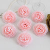 A collection of pink silk peony artificial flowers arranged on a white surface with a pearl necklace and gold object.