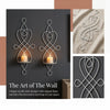 A set of elegant, scroll-style iron wall sconces designed to hold candles.