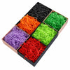 A box filled with various colors of crinkle paper shred filler for Halloween treats and décor.