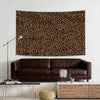 A dark brown leopard print tapestry wall hanging displayed above a dark leather sofa and modern furniture.