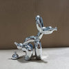 A chrome sculpture of a dog squatting, rendered in a modern art style.