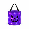 A purple glowing pumpkin candy bucket with a black LED handle.
