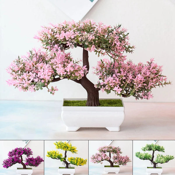 A realistic artificial bonsai tree decor featuring pink blossoms displayed in a white planter.