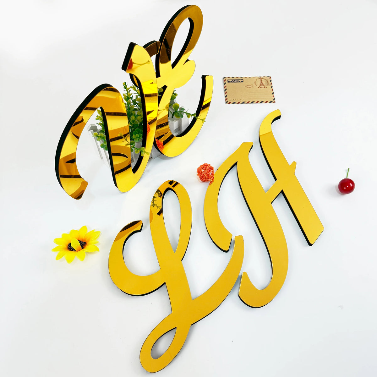 Gold 3D acrylic letter wall stickers spelling 'VH' on a white background with small decorative elements.