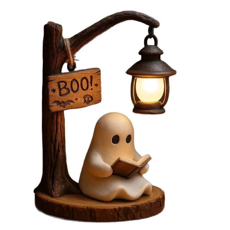 A ceramic ghost figurine reading a book next to a wooden arm with a hanging lantern.