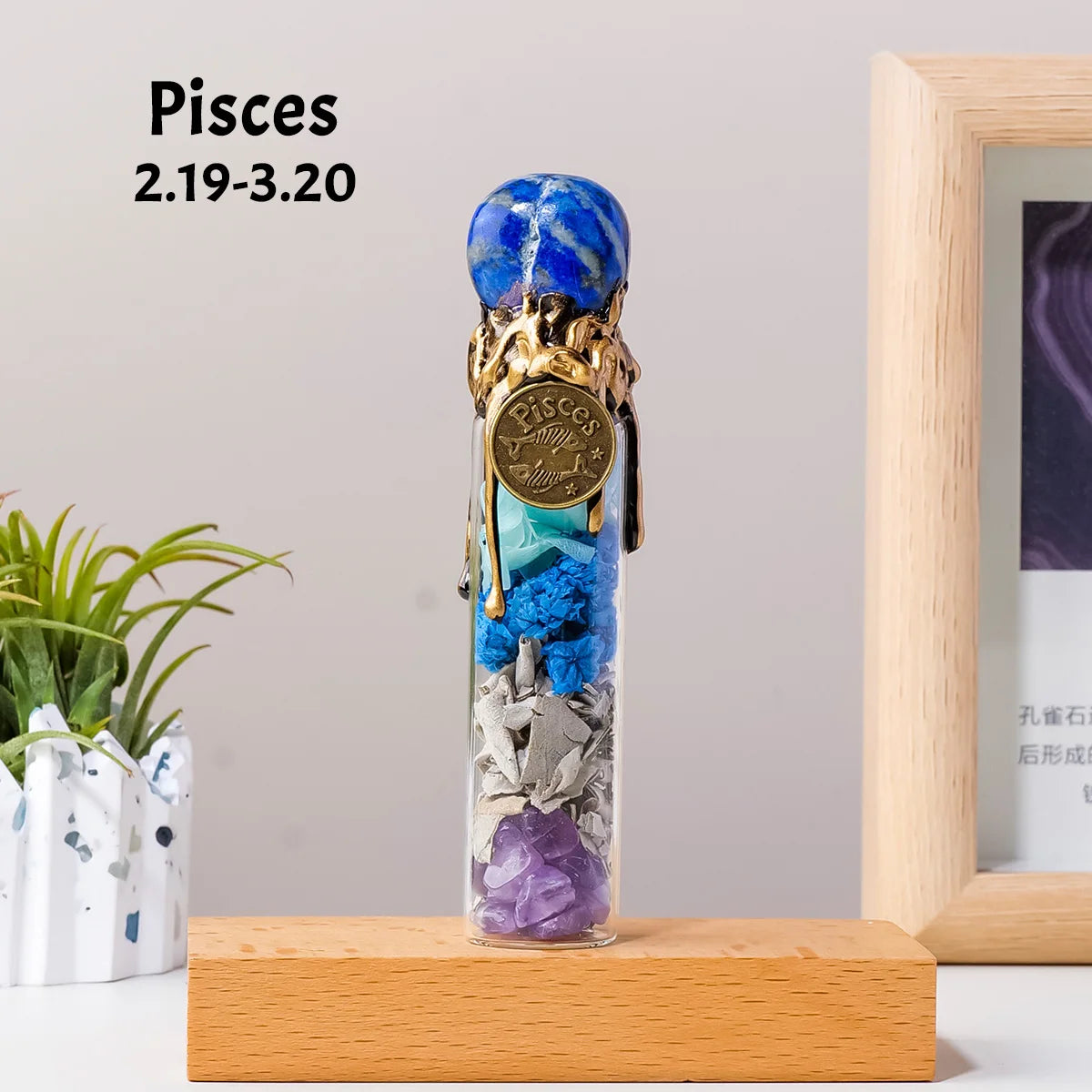 A tall glass bottle filled with various natural crystal stones, including blue and purple minerals, displayed on a wooden sur
