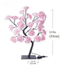 Lampe de table LED noire avec rose et roses roses sur pied.