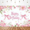 A floral pink birthday backdrop featuring delicate flowers and bows on a white background.
