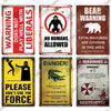A collection of vintage warning metal signs featuring themes like liberals, no humans allowed, and danger warnings.