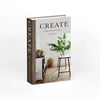 A hardcover book titled CREATE at home with old and new displayed on a wooden stand.