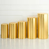 A row of tall, cylindrical gold spandex stands used for event decor.