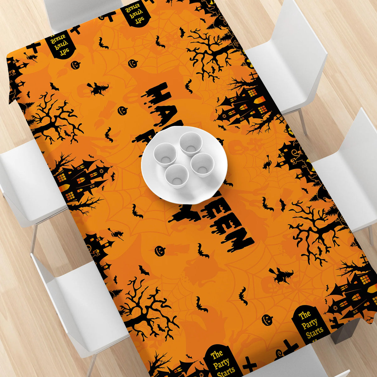 Orange tablecloth featuring a black Halloween pumpkin and ghost pattern.