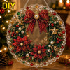 A detailed Christmas wreath made of red and green glitter, pearls, and gold accents, hanging from a metal chain.